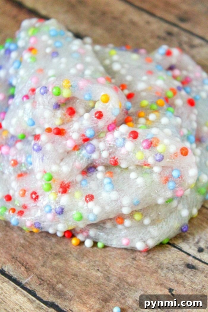 Kids Playing with Borax-Free Slime Child's hands happily stretching a vibrant batch of borax-free foam bead slime.