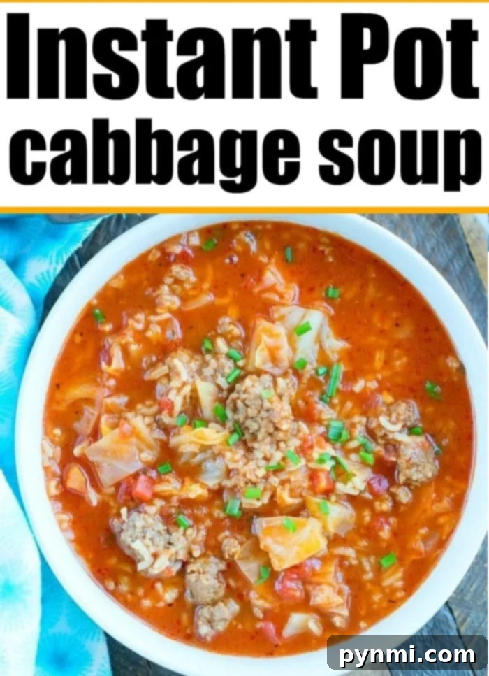 A large pot of hot, steaming Instant Pot cabbage soup, garnished with fresh herbs.