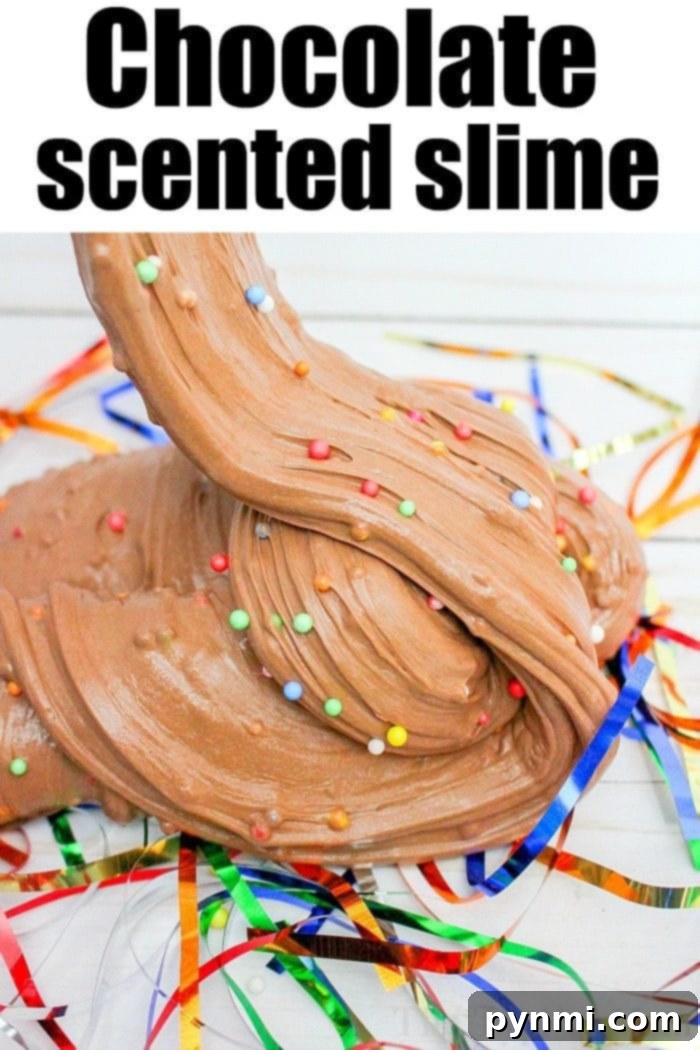 Child's hands playing with soft, brown, chocolate-scented birthday cake slime with colorful sprinkles