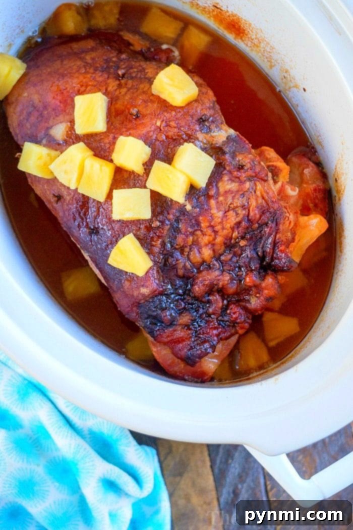 A close-up of a richly glazed Crockpot Ham, highlighting its tender texture and the inviting pineapple crust, a testament to a successful Crockpot Ham Recipe.