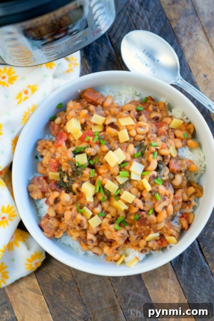 Instant Pot Hoppin John with tender black-eyed peas and ham, garnished with fresh greens