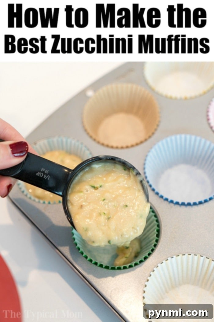 Scooping moist zucchini muffin batter into a lined muffin tin, preparing a batch of delicious homemade muffins.