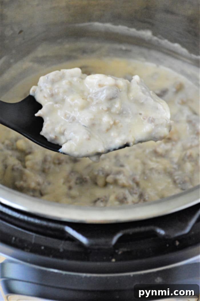 A bowl of creamy Instant Pot Sausage Gravy, ready to be served over biscuits.