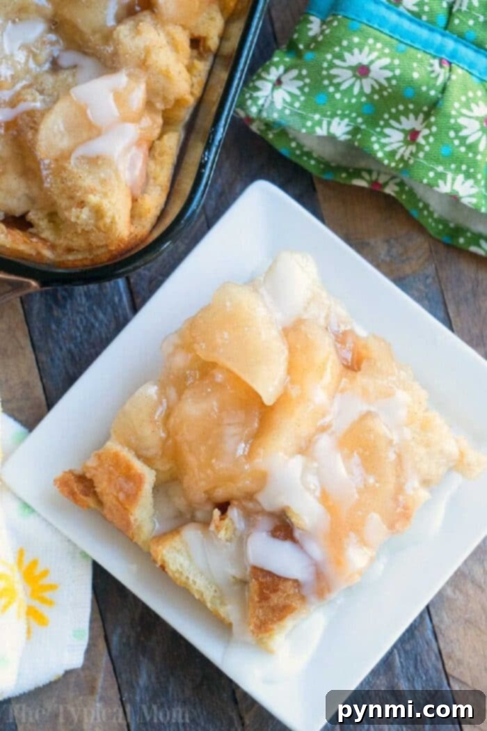 Spiced Apple Pie Bread Pudding 10 Close-up of a warm slice of apple bread pudding, revealing its soft, custardy interior and a generous layer of spiced apple pie filling.