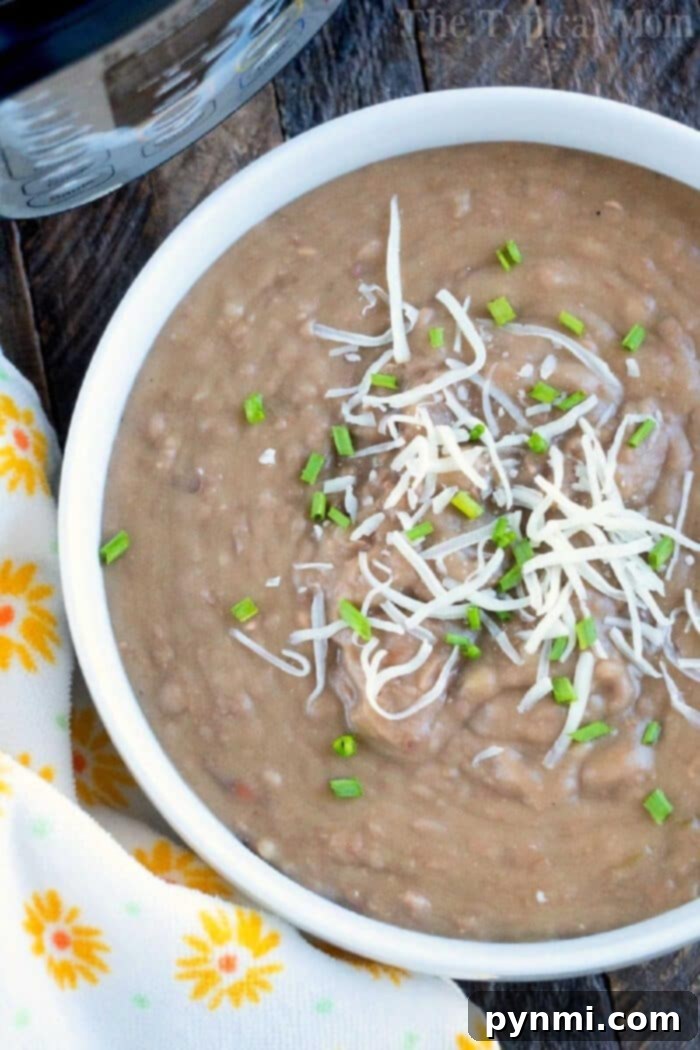 Creamy Pressure Cooker Refried Beans served in a bowl, perfect for burritos or dips.