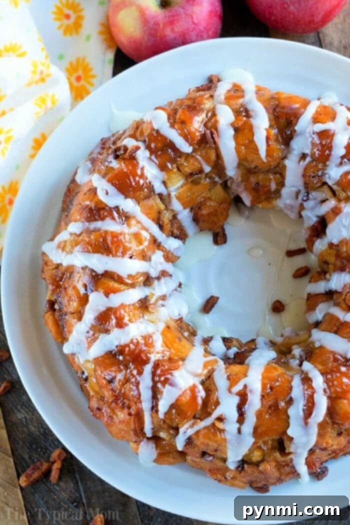 This apple monkey bread is packed full of fresh apples and really delicious! The best monkey bread I've made with refrigerated cinnamon rolls ever. #monkeybread #apple #breakfast #cinnamonroll #best #thetypicalmom Fresh Apple Monkey Bread made with refrigerated biscuits, packed with apples, cinnamon, and a sweet glaze, perfect for breakfast or dessert.