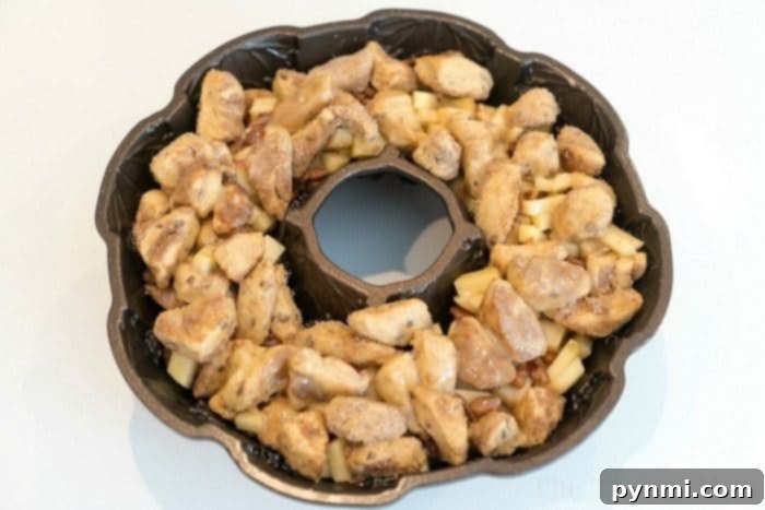 This apple monkey bread is packed full of fresh apples and really delicious! The best monkey bread I've made with refrigerated cinnamon rolls ever. #monkeybread #apple #breakfast #cinnamonroll #best #thetypicalmom Easy apple monkey bread, a delicious breakfast or dessert idea.