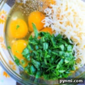 A bowl with cracked eggs, shredded cheese, chopped greens, and seasoning sits ready for mixing to create pressure cooker egg bites.