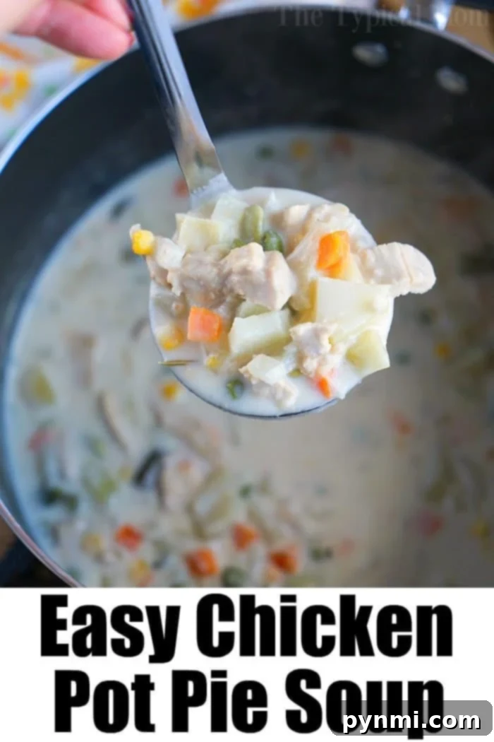 A ladle filled with creamy turkey pot pie soup hovering over a steaming pot, ready to be served.