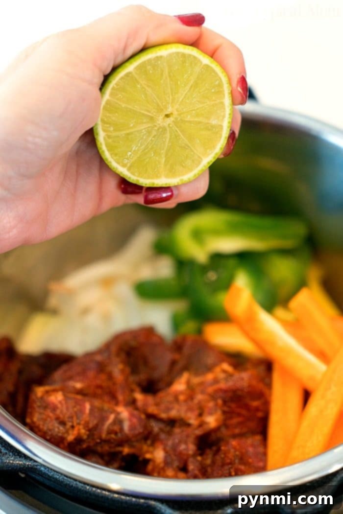 Close-up of tender Instant Pot fajita beef with cooked bell peppers and onions
