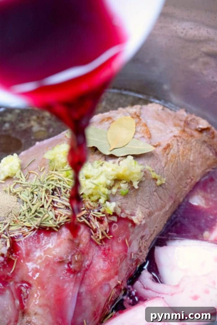Close-up of shredded Instant Pot roast beef with rich gravy.