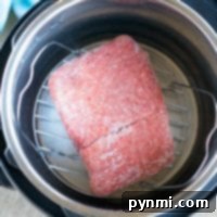 Instant Pot frozen ground beef sits on a trivet, poised for cooking perfection.