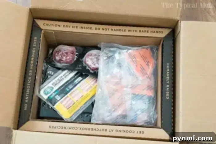 An open ButcherBox delivery with two packs of ground beef, bacon, and other orange-labeled items, ideal for pressure cooker meals.
