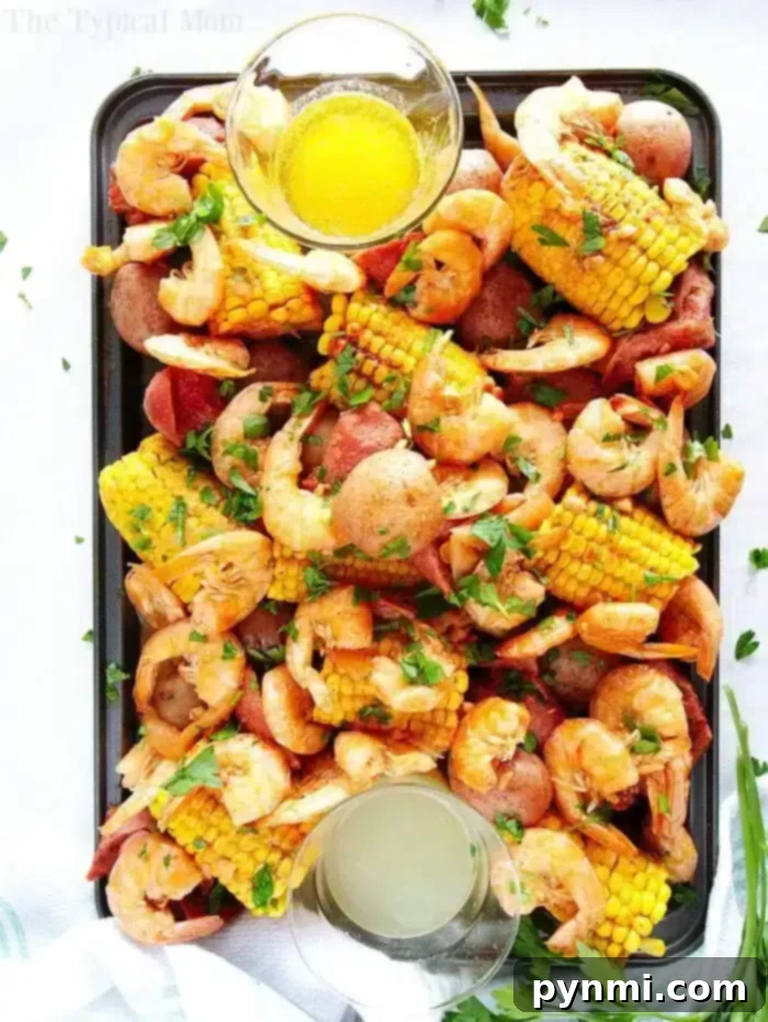 A vibrant Instant Pot shrimp boil with shrimp, corn, potatoes, and sausage, garnished with parsley.