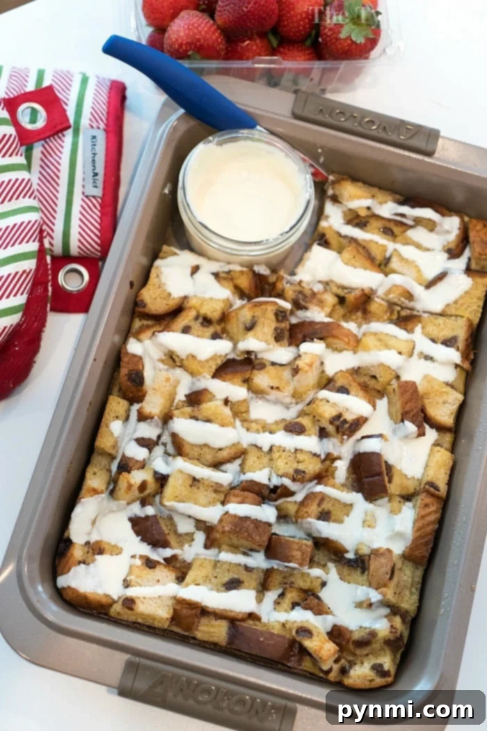 Close-up of a warm, golden raisin bread pudding slice, showing the moist custard and plump raisins.