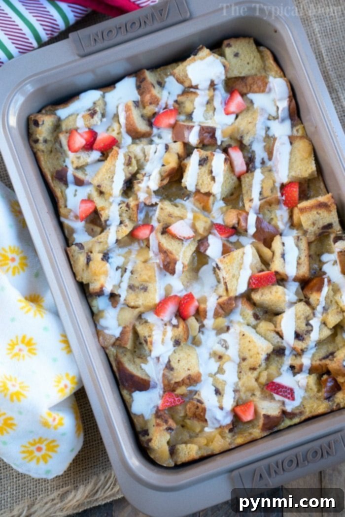 Overhead view of a baking dish filled with freshly baked raisin bread pudding, still warm and steaming lightly.
