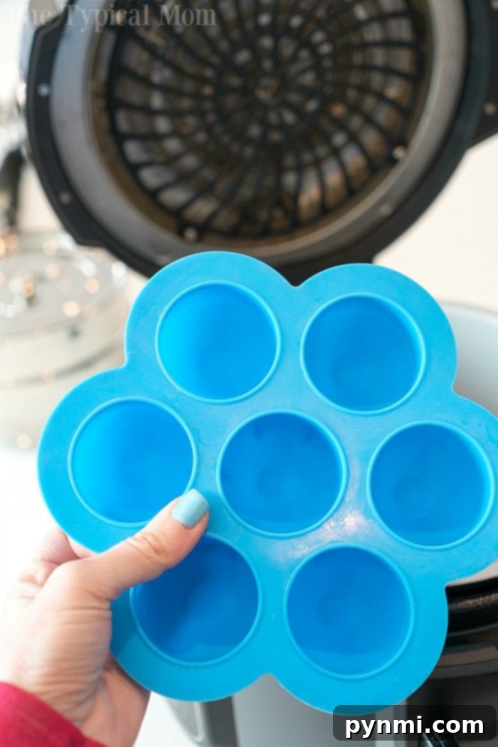 A blue silicone egg mold with six compartments, ideal for making egg bites, muffins, and other creative pressure cooker treats.