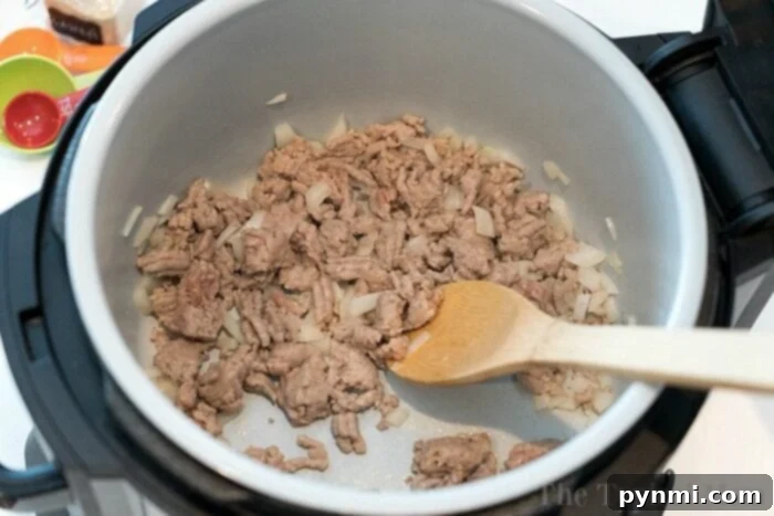 A bowl of creamy, cheesy taco pasta made in a pressure cooker