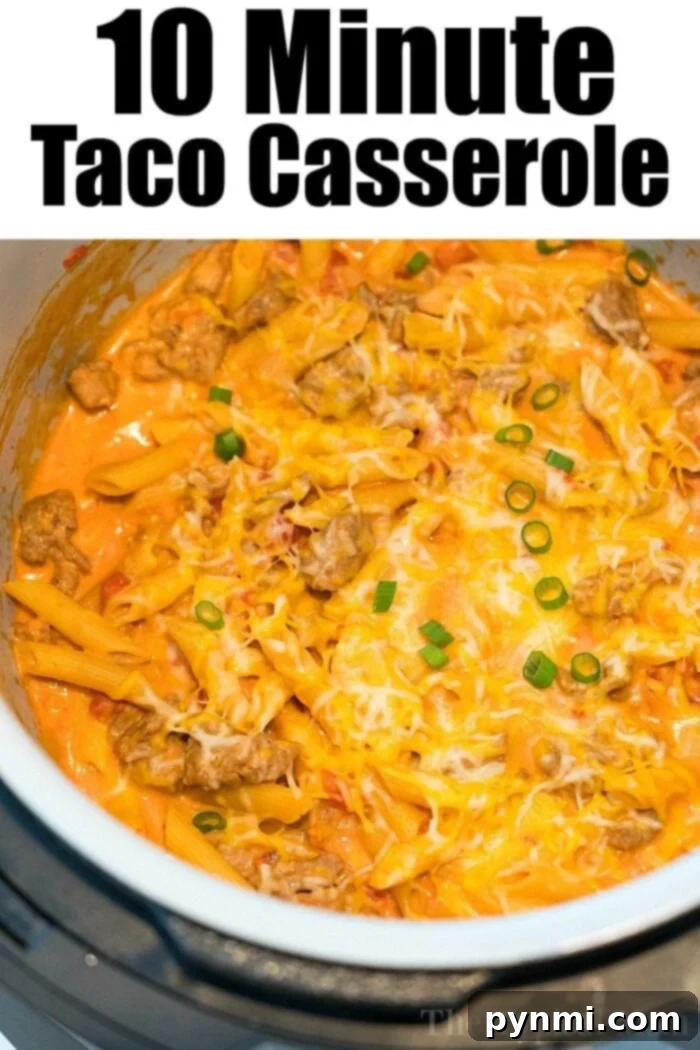 A Ninja Foodi taco casserole with ground meat, melted cheese, pasta, and sliced green onions. Text at the top reads, "10 Minute Taco Casserole.