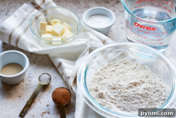 A selection of raw ingredients including flour, yeast, brown sugar, and salt, laid out for making air fryer pretzel bites.