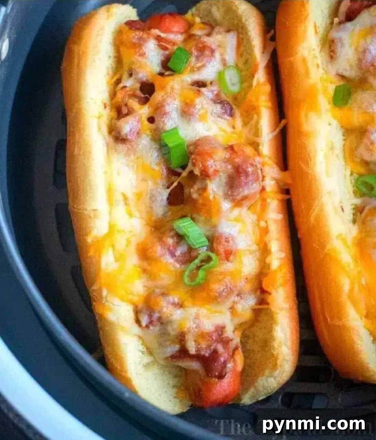 Crispy Air Fryer Franks 2 An air fryer hot dog topped with rich chili, gooey melted cheese, and fresh chopped green onions, nestled in a perfectly toasted bun.