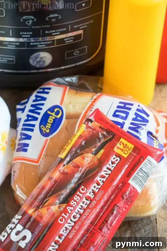 Air Fryer hot dogs or chili dogs are the perfect quick dinner idea our whole family loves! Load your buns up with toppings & they come out nice & crispy. #airfryer #hotdogs #chilidogs #ninjafoodi #ninjafoodirecipes A package of classic lunch franks and Hawaiian hot dog buns ready for air frying, symbolizing convenience and deliciousness.
