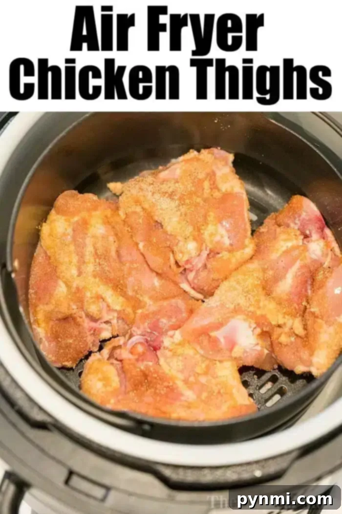 Best air fryer chicken thighs ever! Use this dry rub for chicken to make sweet and crispy chicken in an air fryer that's tender and juicy inside. Yum! #airfryerrecipes #airfryer #ninjafoodirecipes #ninjafoodi #chickenthighs #chicken #crispy Image of raw, bone-in air fryer chicken thighs seasoned and placed inside an air fryer, ready to cook. The text above the image reads "Air Fryer Chicken Thighs.