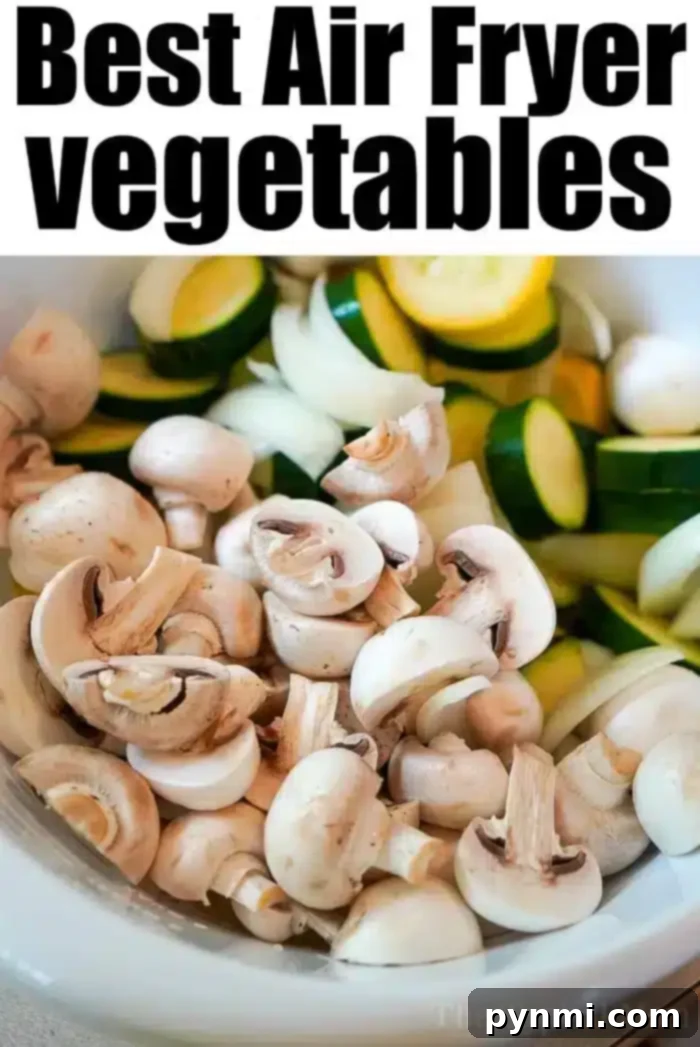 Crispy Air Fryer Vegetables 5 A white bowl brimming with air fryer vegetables like sliced mushrooms, zucchini, and onions. The text above reads, "Best Air Fryer Vegetables.
