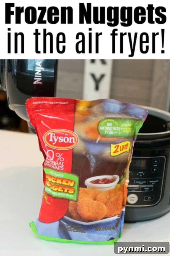 A perfectly cooked plate of air fryer frozen chicken nuggets, golden and ready for dipping, accompanied by a side of fresh sauce.