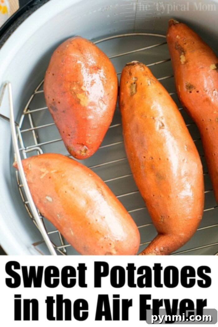 Fluffy sweet potato in the air fryer recipe is here! Sweet potatoes are the best side dish for the holidays or year round. Crispy outside but tender inside. #airfryerrecipes #airfryer #sweetpotato #sweetpotatoes #potatoes #ninjafoodirecipes #ninjafoodi #thetypicalmom Four sweet potatoes rest on a rack inside the ninja foodi, perfectly positioned for an even cook.