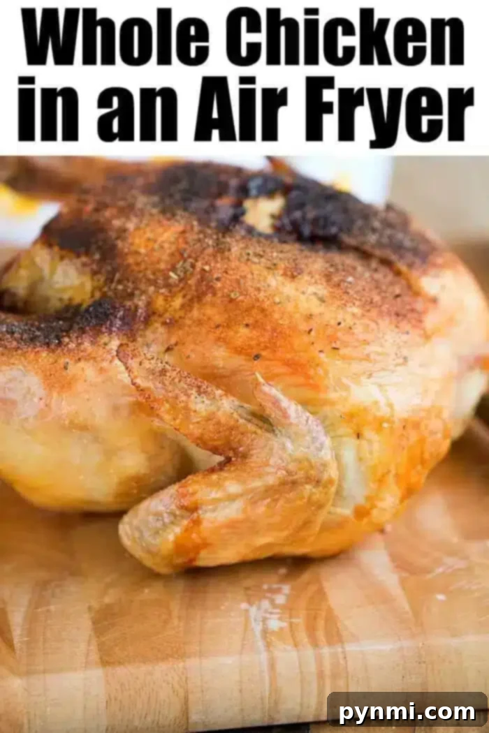 A cooked air fryer whole chicken with crispy, golden-brown skin is placed on a wooden cutting board. The text at the top reads, "Whole Chicken in an Air Fryer.