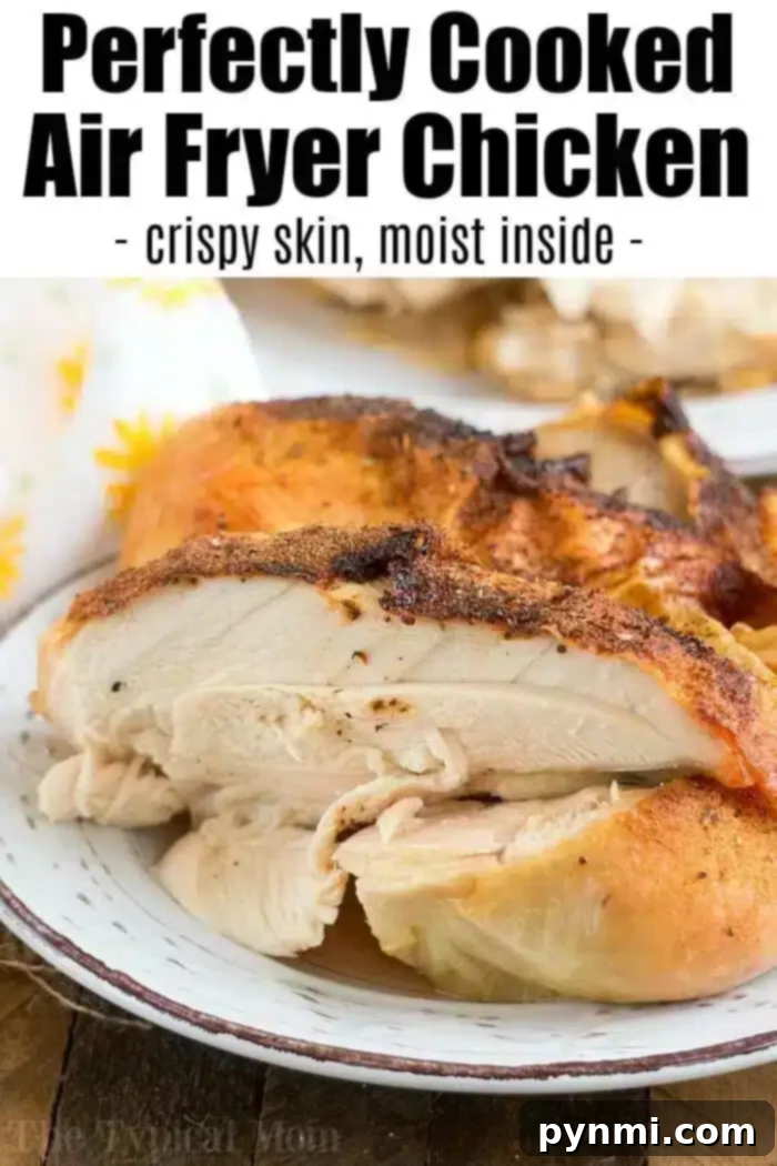 A serving of air fryer whole chicken is shown on a plate. The chicken has crispy skin and a moist interior, as described in the text overlay. The text reads, "Perfectly Cooked Air Fryer Chicken - crispy skin, moist inside.