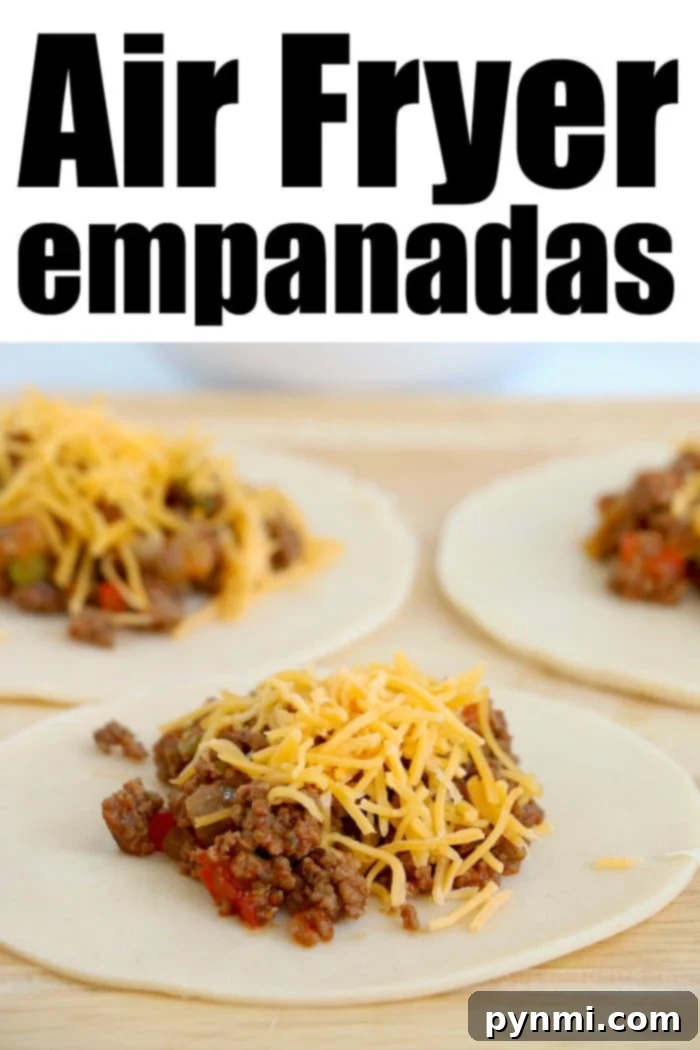 Empanadas cooking in an air fryer basket
