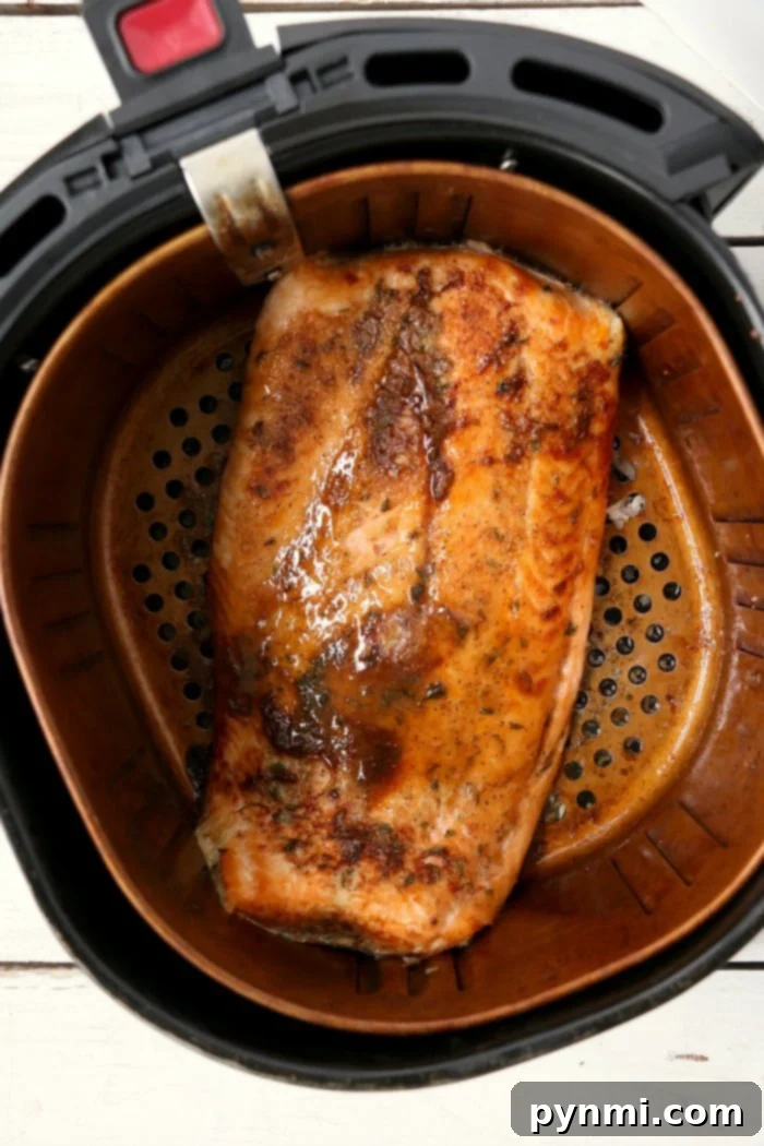 Salmon cooking in an air fryer