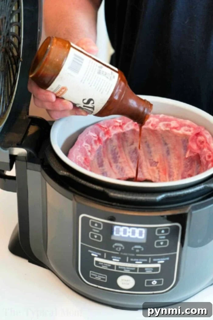 Tender, flavorful pork ribs cooked in a Ninja Foodi, coated in a savory barbecue glaze, resting on a serving platter with garnishes.