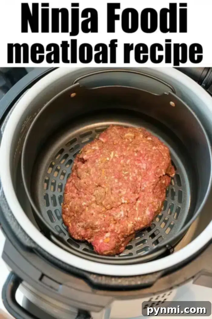 A raw ninja foodi meatloaf sits inside the appliance, ready for cooking. The text above reads "Ninja Foodi meatloaf recipe.