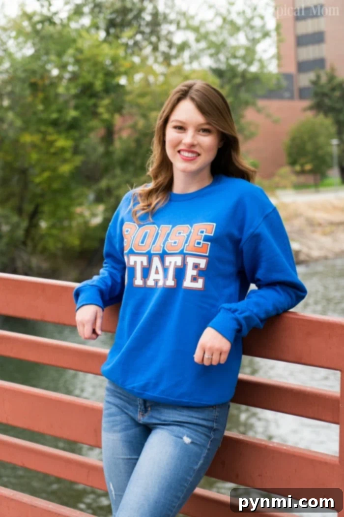 A lifestyle blogger showcasing beautiful Minted High School graduation invitations with intricate designs.