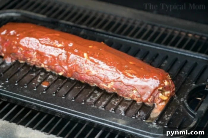 A serving of smoked meatloaf with a generous portion of melted cheese visible within, garnished with fresh herbs. This image highlights the tempting appeal of a cheese-stuffed smoked meatloaf, perfect for a hearty meal.