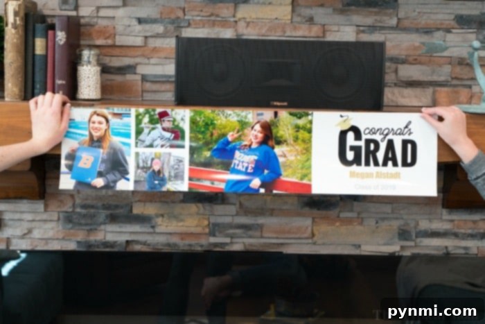 Smiling graduate next to her personalized graduation banner