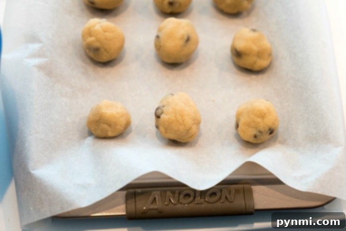 Assortment of edible cookie dough bites, some plain, some with a touch of vanilla frosting, on a white plate. A perfect, customizable dessert.