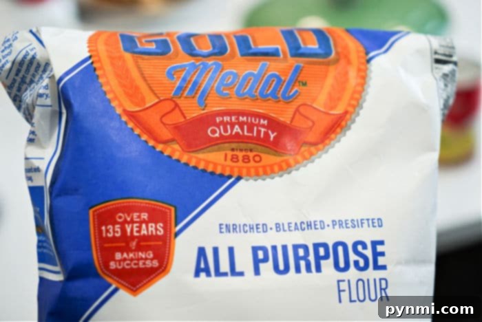 Close-up of all-purpose flour on a baking sheet, illustrating the heat-treating process for safe edible cookie dough.