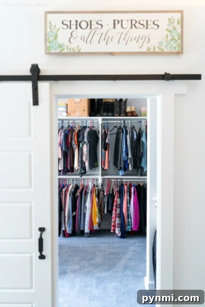 Stunning walk-in closet created from a former bedroom, showcasing ample storage and elegant design.