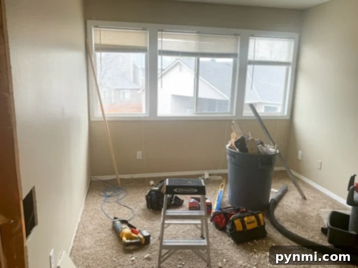 Interior of the DIY walk-in closet with built-in shoe racks and benches under the windows.