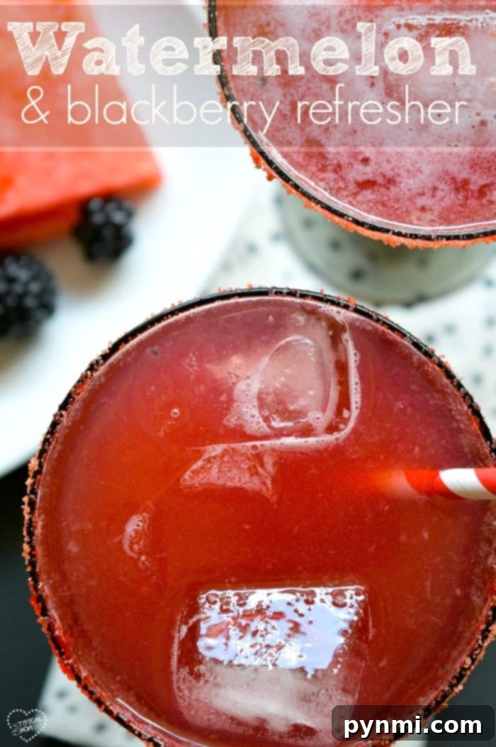 A refreshing watermelon cocktail garnished with a slice of watermelon and mint, sitting poolside.