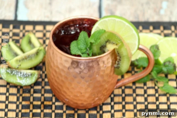 A classic Moscow Mule in a copper mug, garnished with a lime wedge and mint sprig.