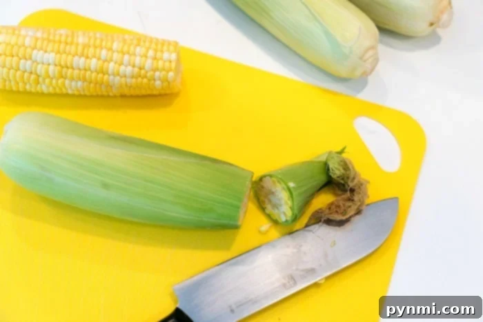 Image showing how to prepare corn by removing husks and silk for air frying.