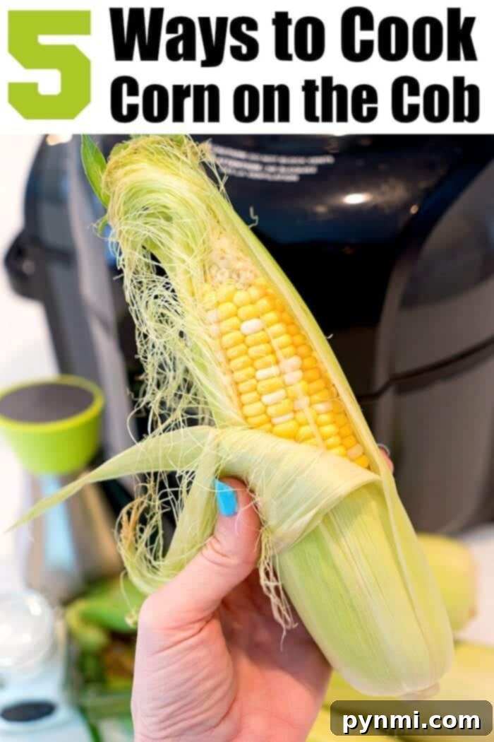 A hand holding an ear of corn partially husked with a blurred kitchen background. Text at the top reads: "5 Ways to Cook Corn on the Cob, including Air Fryer Corn.