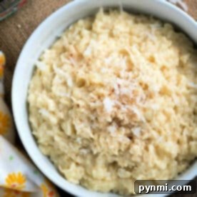 A bowl of creamy coconut rice pudding topped with shredded coconut and a sprinkle of cinnamon.
