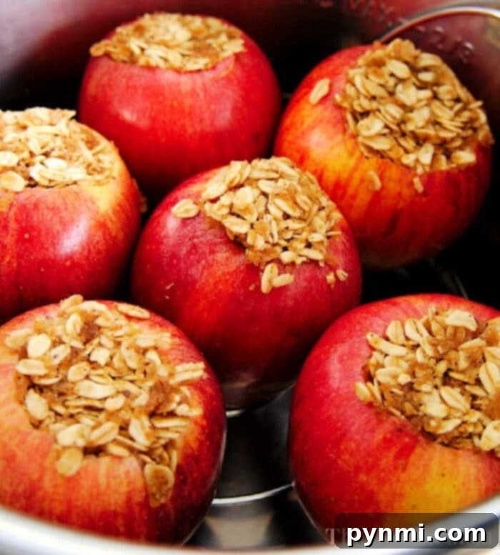 Perfectly cooked whole pressure cooker baked apples on a plate, ready to be served