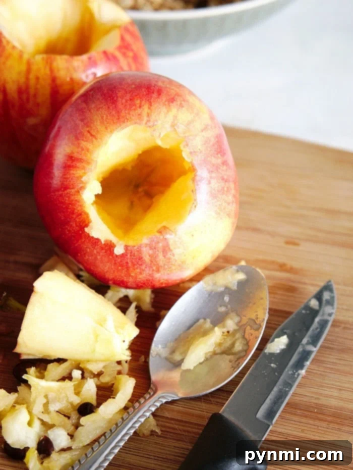Close-up of apples being cored and stuffed with an oat mixture for pressure cooking